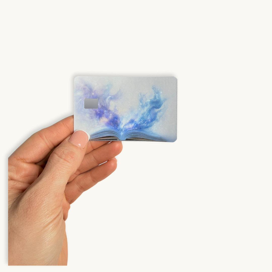 Dreamy fantasy aesthetic card cover, open book releasing blue galaxy magic mist design."
