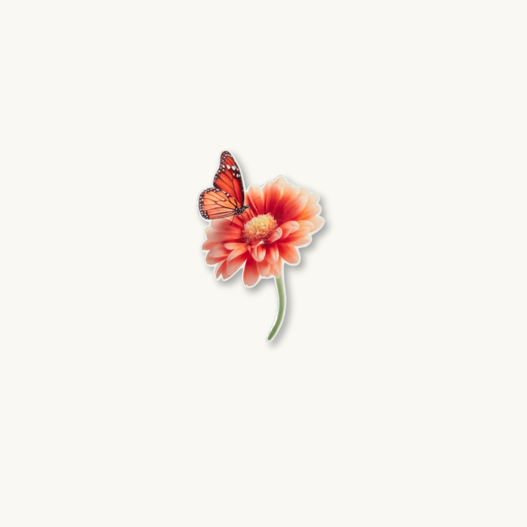 The Literal One: "Monarch butterfly resting on a coral gerbera daisy sticker, botanical nature vinyl decal.