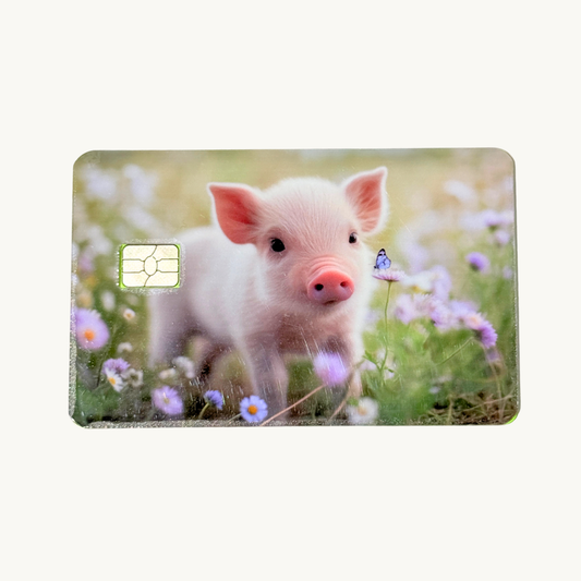 Cute baby piglet standing in purple wildflower meadow with blue butterfly debit card skin waterproof vinyl by The Sticker Era