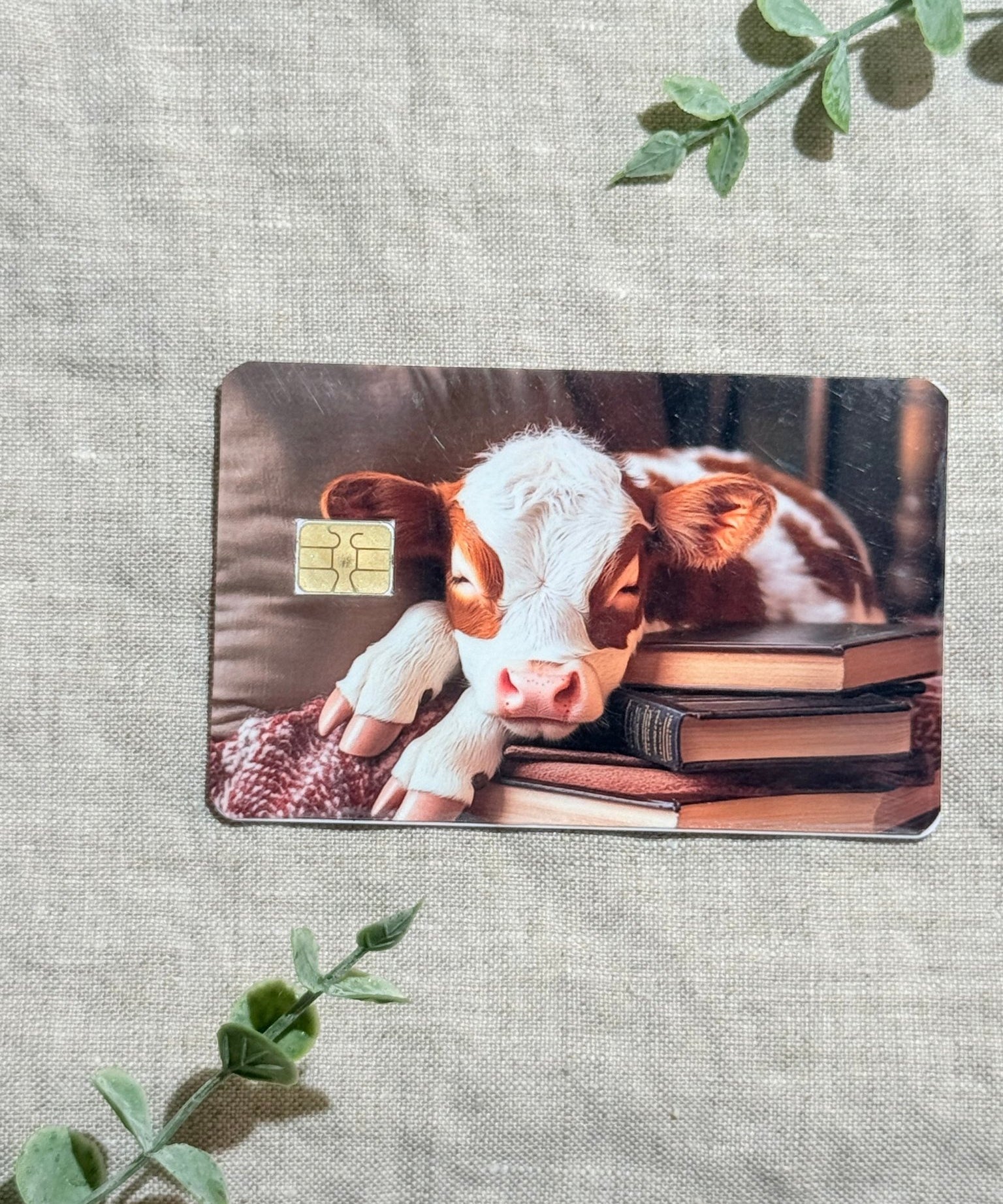 Cozy Bookish Baby Cow Card Skin | Sleepy Cow on Books by The Sticker Era