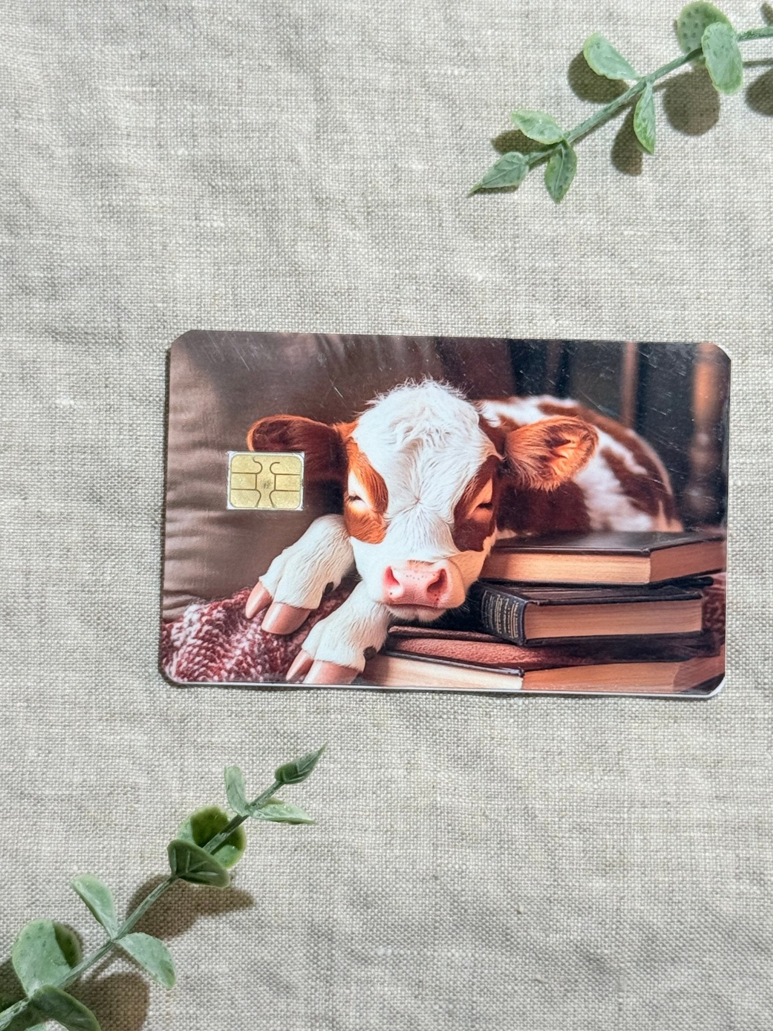 Cozy Bookish Baby Cow Card Skin | Sleepy Cow on Books by The Sticker Era