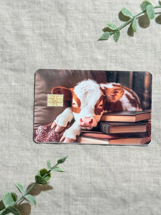 Cozy Bookish Baby Cow Card Skin | Sleepy Cow on Books by The Sticker Era