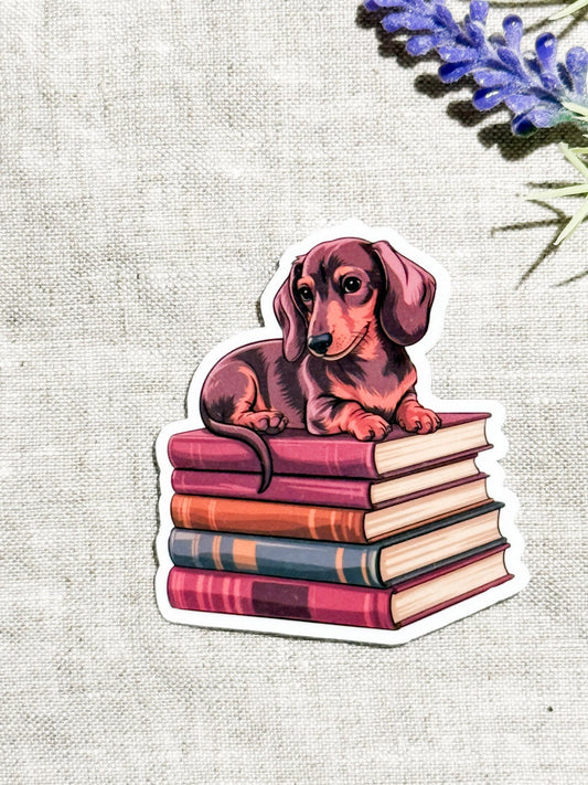 Dachshund on Books Sticker | Cute Bookish Dog Vinyl Decal by The Sticker Era