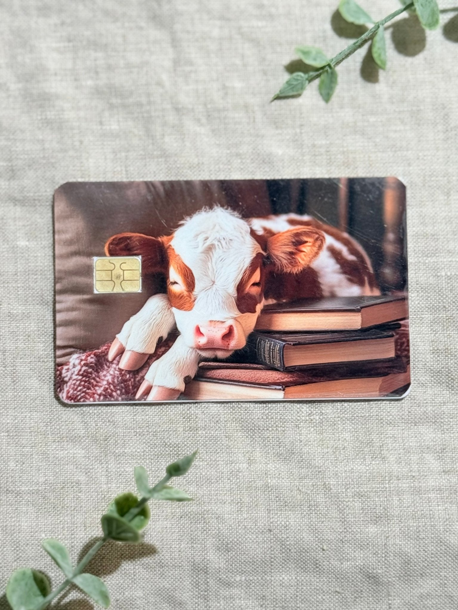 Cozy Bookish Baby Cow Card Skin | Sleepy Cow on Books by The Sticker Era