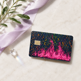 Hot pink flame card skin with holographic glitter on a debit card beside lavender ribbon and olive leaves by The Sticker Era