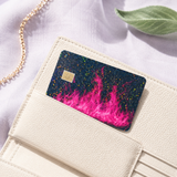 Holographic pink flame credit card skin sitting in a cream cardholder wallet by The Sticker Era