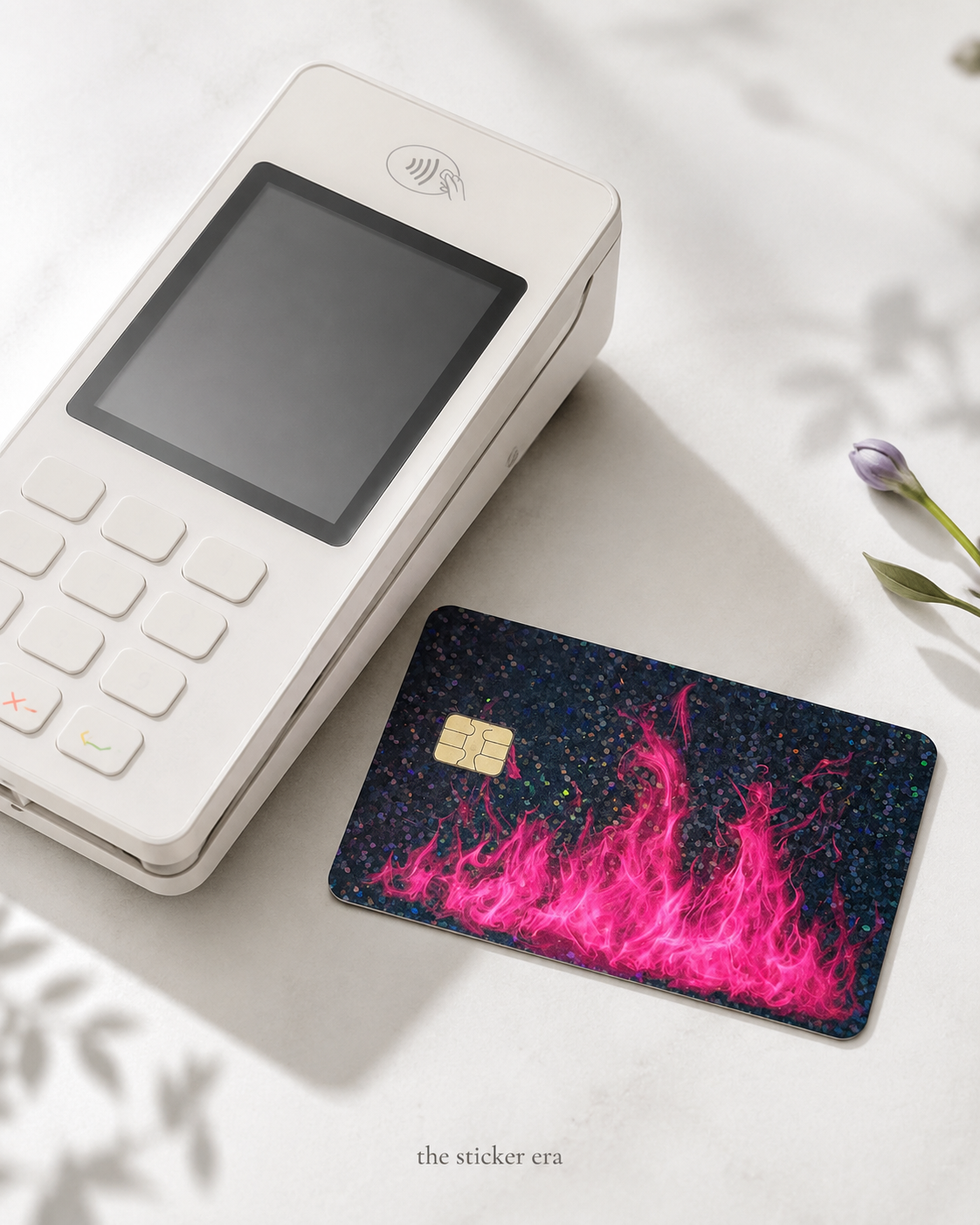 Hot pink flame card skin on a debit card next to a checkout card reader by The Sticker Era