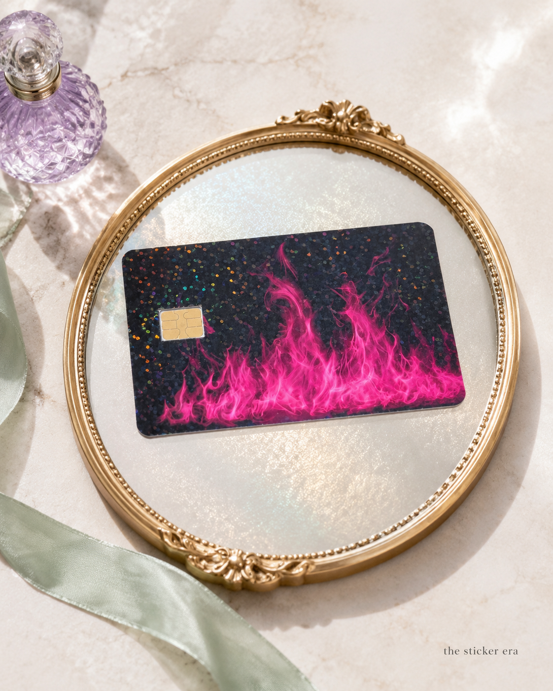 Pink flame glitter card skin displayed inside a gold oval frame by The Sticker Era