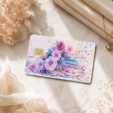 Pastel floral book card skin on white marble with dried flowers, cream books and a gold necklace by The Sticker Era