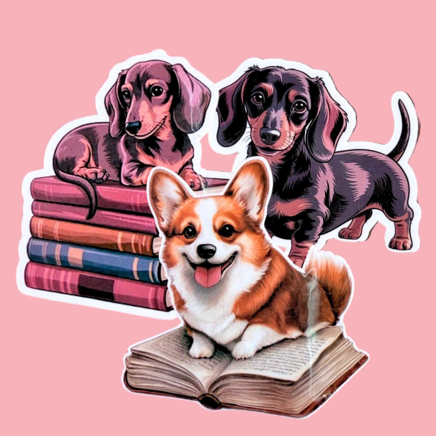 Three book-themed dog vinyl stickers including a corgi and dachshunds displayed on a soft pink background. __etsy:7781474903