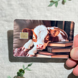 Cozy Bookish Baby Cow Card Skin | Sleepy Cow on Books by The Sticker Era
