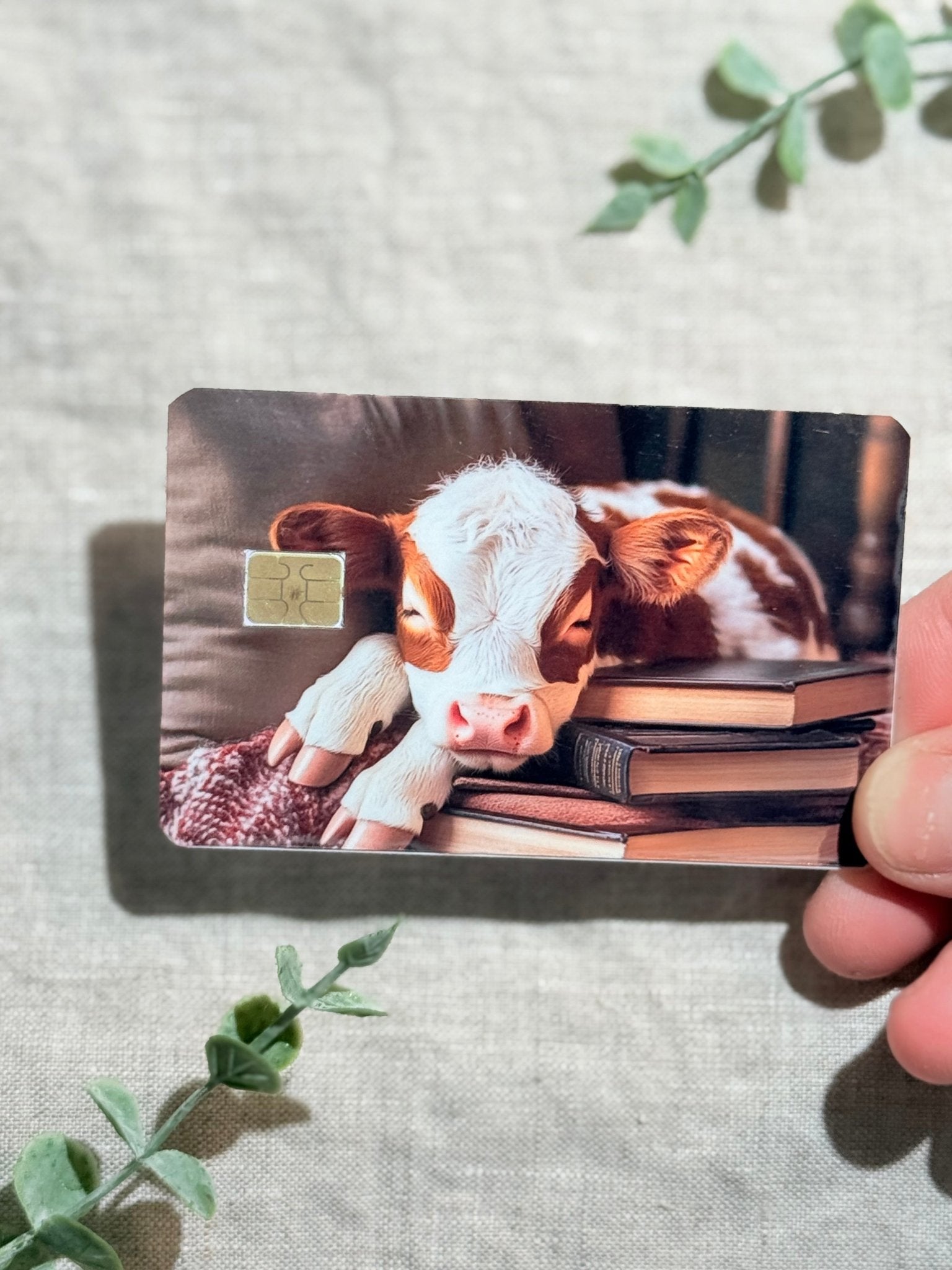Cozy Bookish Baby Cow Card Skin | Sleepy Cow on Books by The Sticker Era
