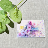 Pastel nurse floral bookish vibe credit card skin with roses and a little stack of books and a gold chip on grey linen with a eucalyptus sprig by The Sticker Era
