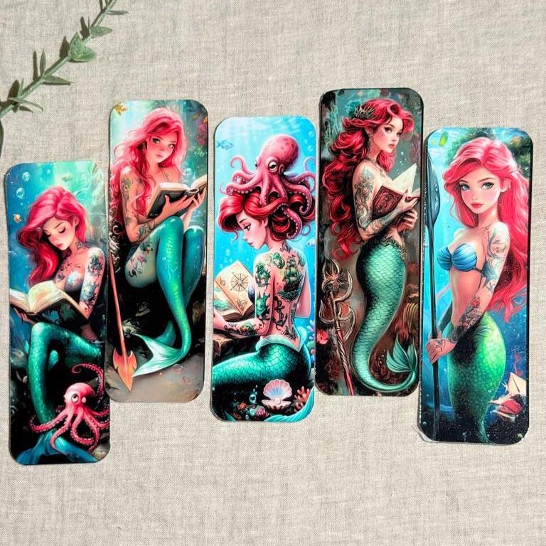 5 differnt styled mermaids with red hair and a octopus with tattoo book mark. First one is looking down reading with octopus beside it. Second one is looking at you with a open book. third one shows the mermaids tattoos back  with cute octopus on it's head while reading. Third is a very powerful red mermaid standing holding book, and last one is a mermaid looking at you with a trident. __etsy:8125608128