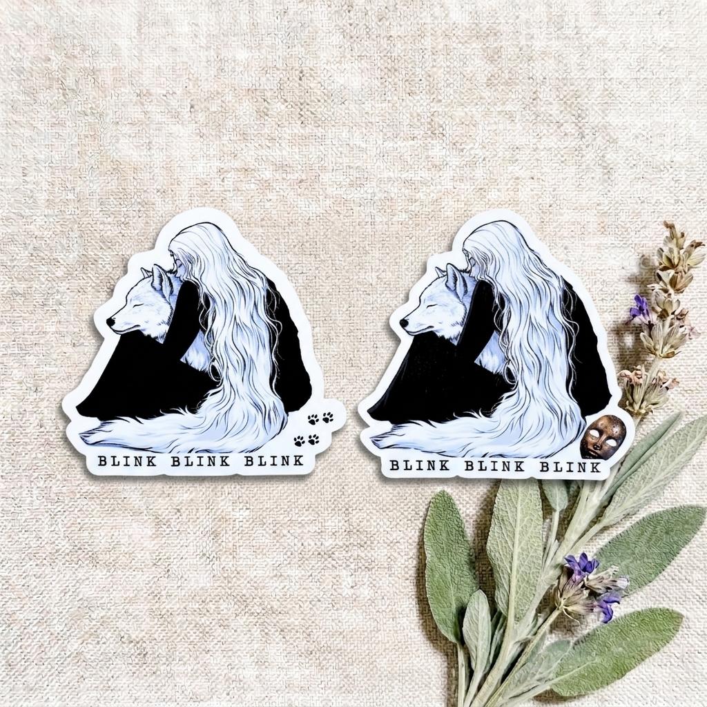 Two fantasy wolf girl die-cut stickers showing a long-haired girl embracing a white wolf with the words BLINK BLINK BLINK, displayed on a linen background with dried lavender and sage botanicals. __etsy:8134308834