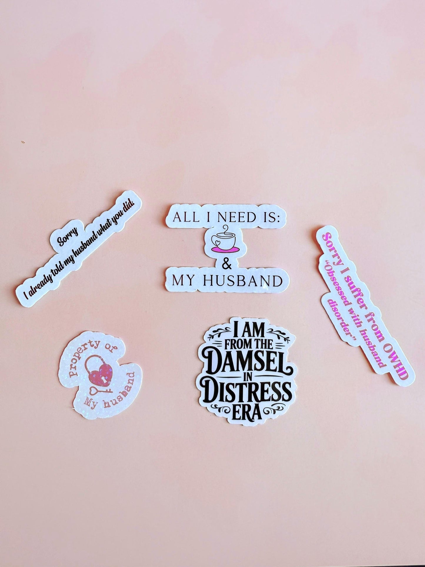 Five vinyl stickers on a pink background featuring husband-themed phrases, including “OWHD,” “Damsel in Distress Era,” and “Property of My Husband.” __etsy:6968419253