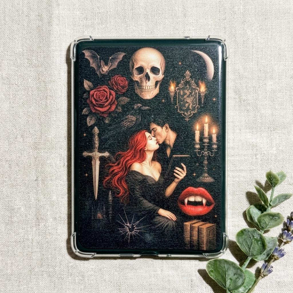 Gothic vampire Kindle insert decal shown on the back of a clear e-reader case, styled on linen with eucalyptus and lavender sprigs. The dark romantasy art shows a red-haired woman kissing a vampire, with a skull, red roses, a bat, a dagger, candles, and a crescent moon. __etsy:8109371078