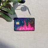 Close-up of hot pink flame card skin with holographic sparkle in natural sunlight by The Sticker Era