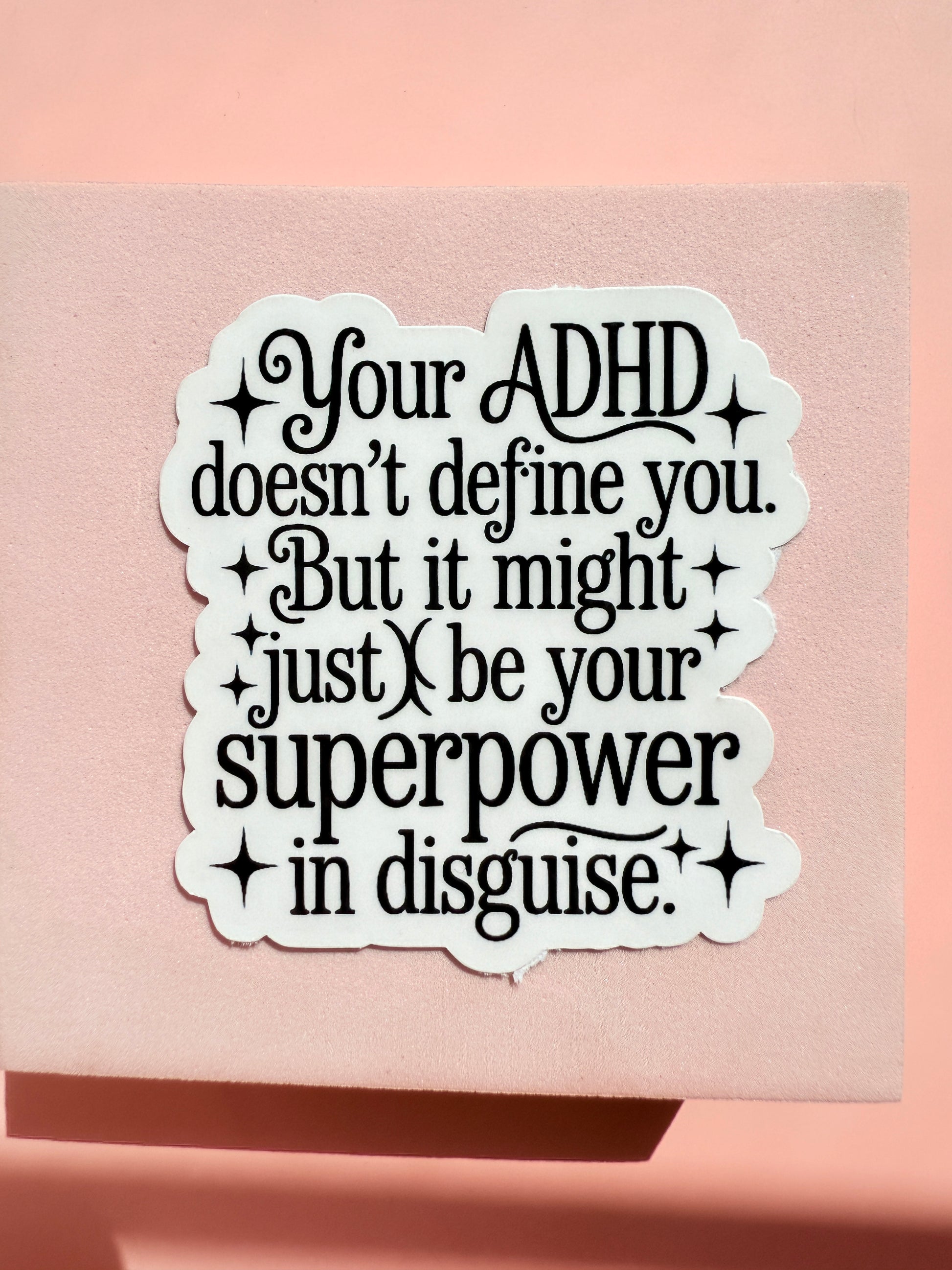 ADHD positive affirmation decal next to a Kindle Paperwhite to show its perfect 3-inch accessory size.