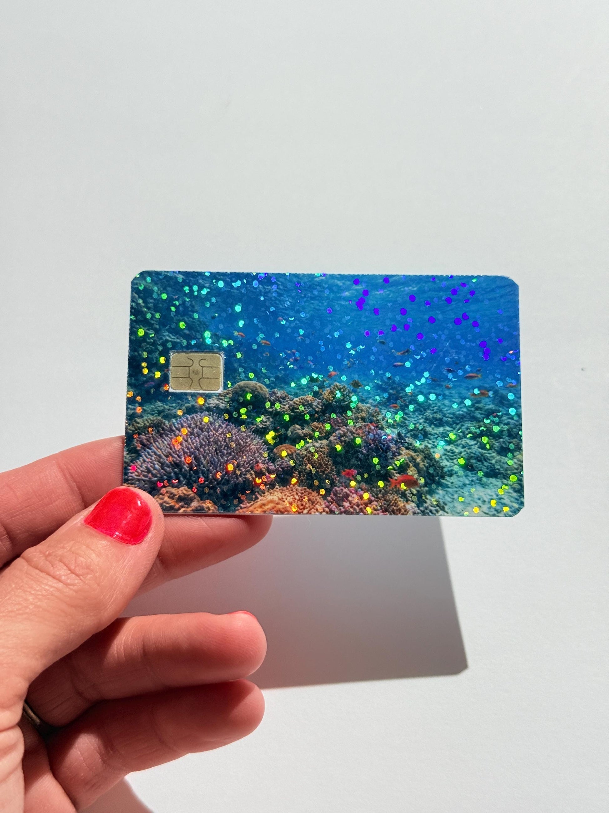 Hand holding coral reef card skin on debit card by The Sticker Era __etsy:8001198389