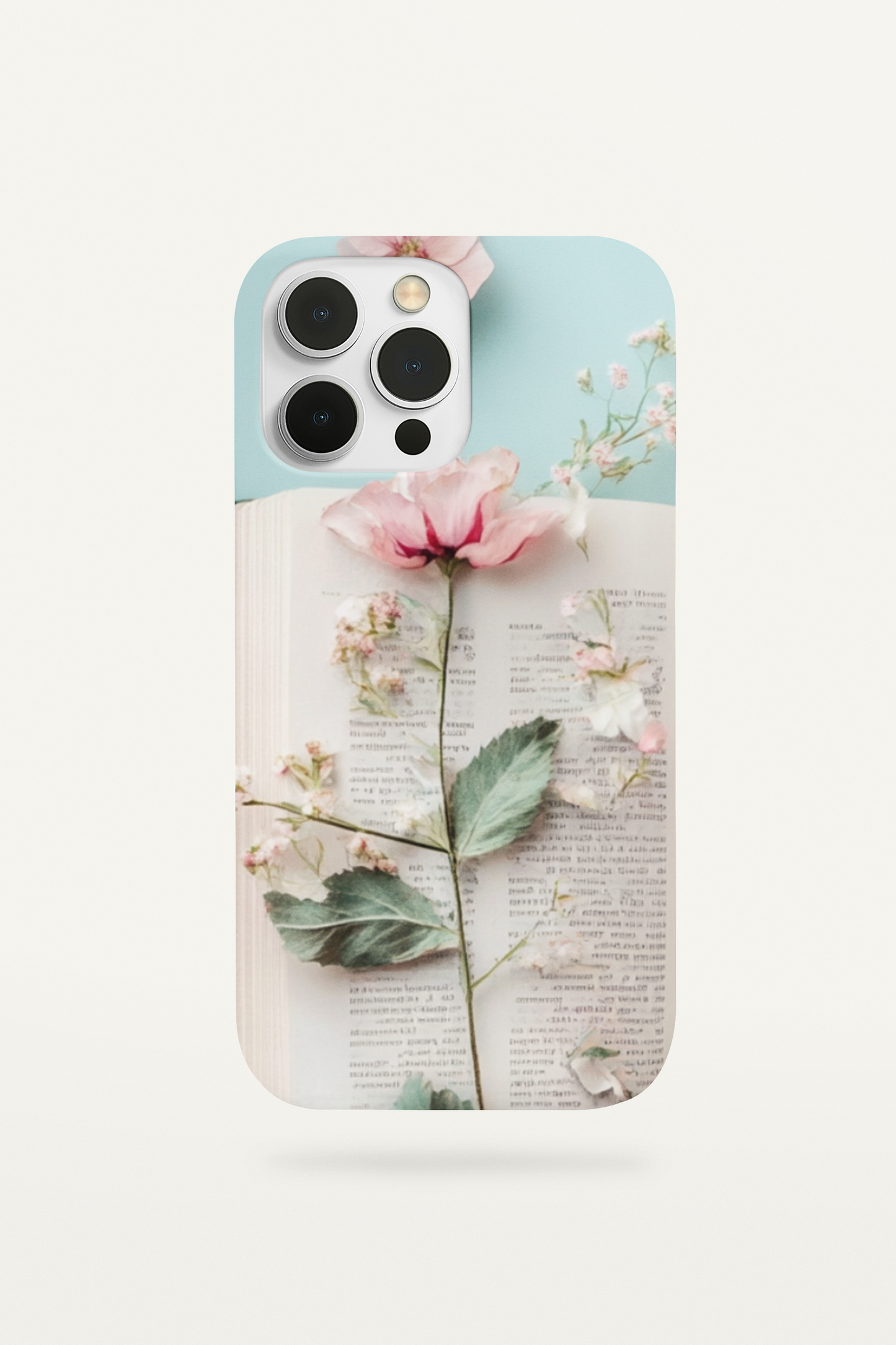 Vintage-style phone insert featuring a pink pressed flower on top of aged book pages for clear iPhone cases.
