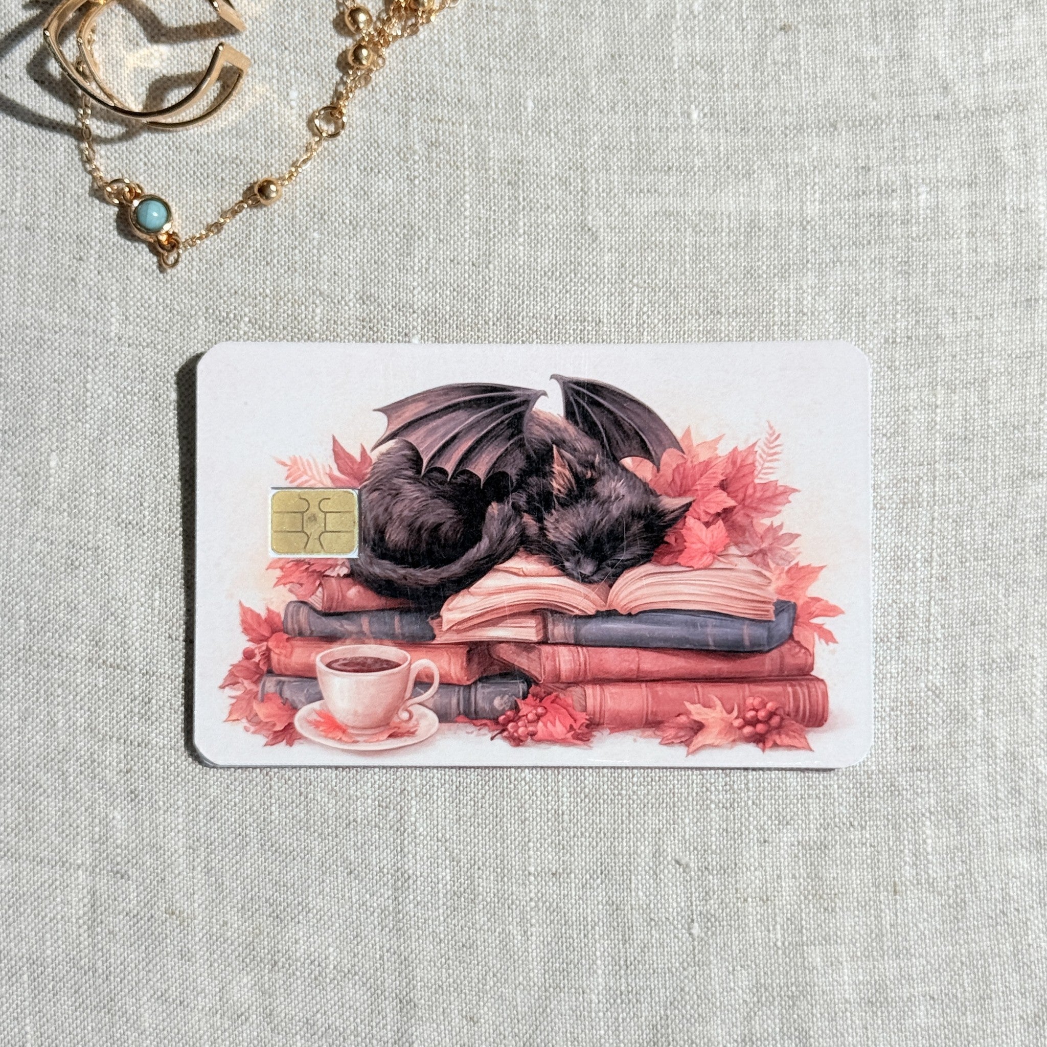 Cozy books and coffee debit card sticker shown flat on linen