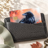 Raven debit card skin tucked in a black leather card wallet with a fall leaf by The Sticker Era