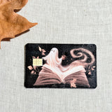Close up of the ghost and open book design with the chip cutout