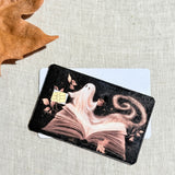 Two book ghost card skins stacked to show the standard and sparkle finishes