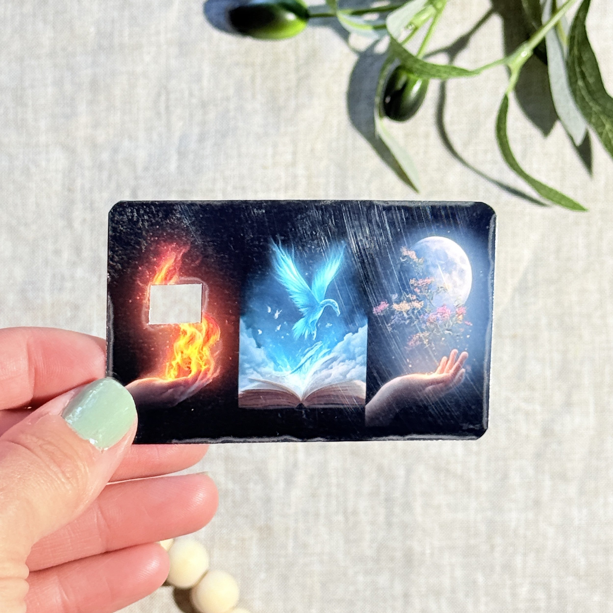 Hand holding the elemental magic fire phoenix moon card skin by The Sticker Era