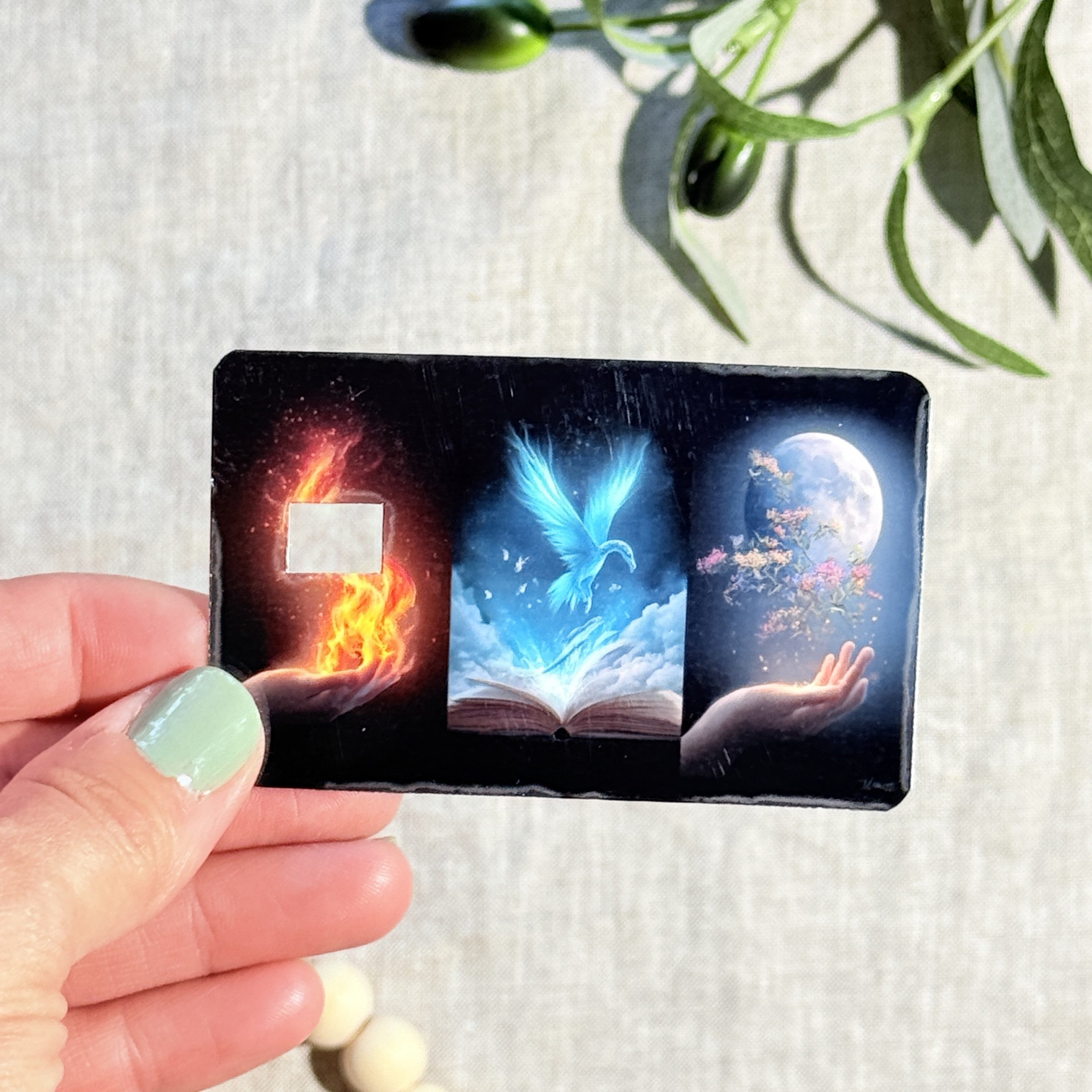 Close-up of the blue phoenix rising from an open book on the card skin by The Sticker Era