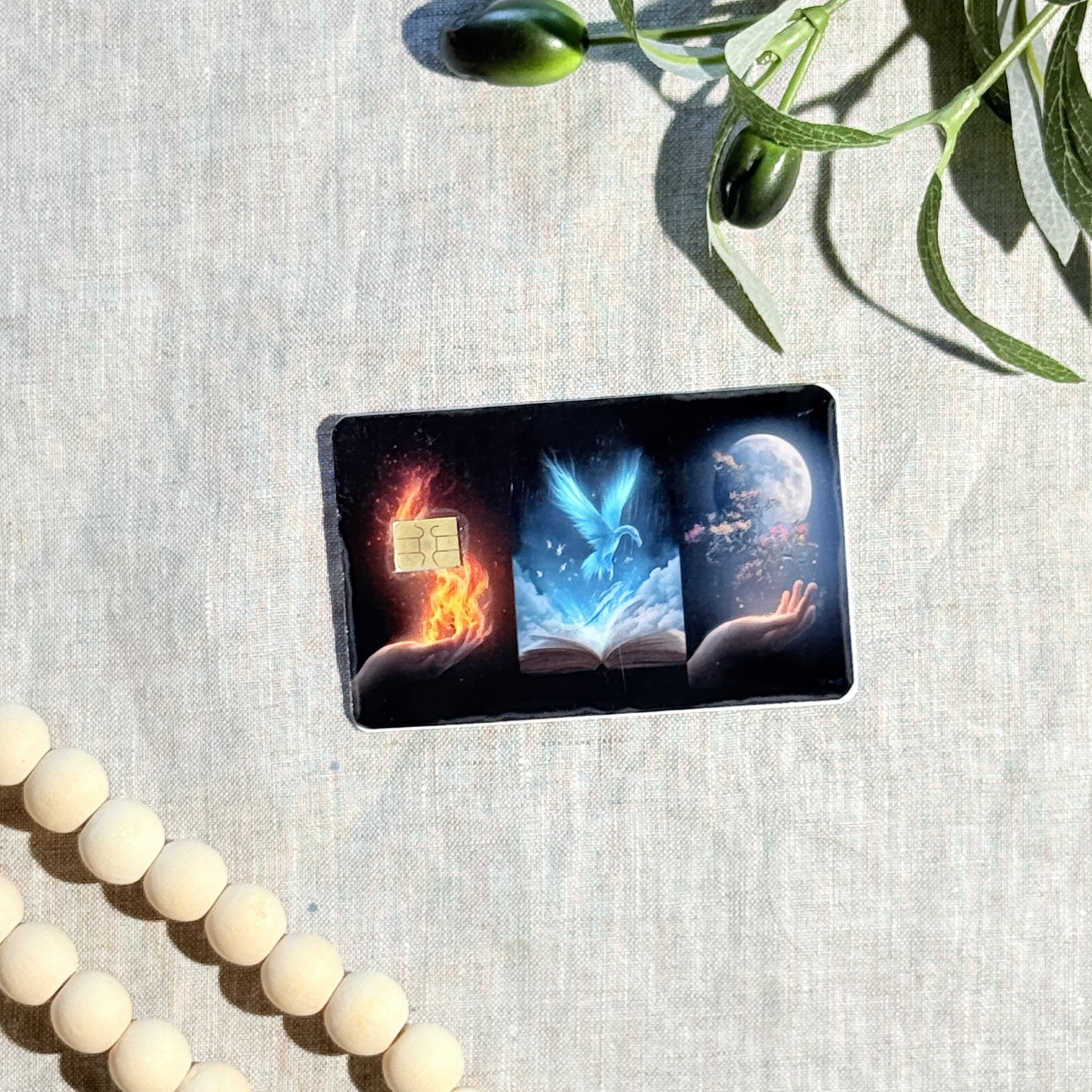 Fantasy triptych card skin held up in sunlight by The Sticker Era