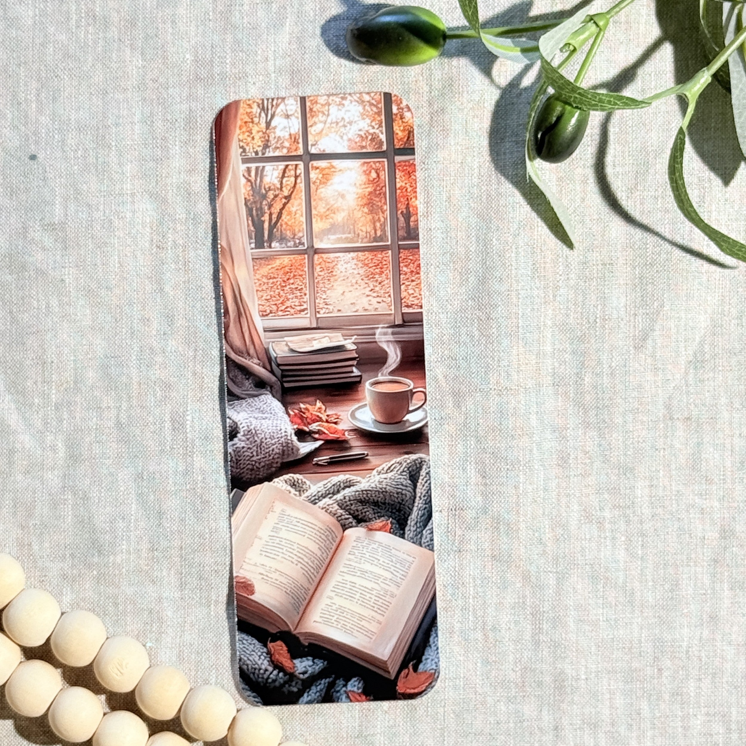Cozy autumn reading nook bookmark with fall window, books and coffee mug by The Sticker Era