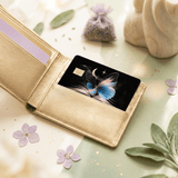 Decorative sticker slipped into open gold bifold wallet surrounded by dried lavender sachet, pressed petals BY THE STICKER ERA