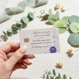 Hand holding  a romantic credit card sticker smooth over a bowl of flowers by The Sticker Era