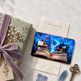 Enchanted storybook card skin beside a sage gift box with a velvet ribbon, pressed flowers and a brass key by The Sticker Era