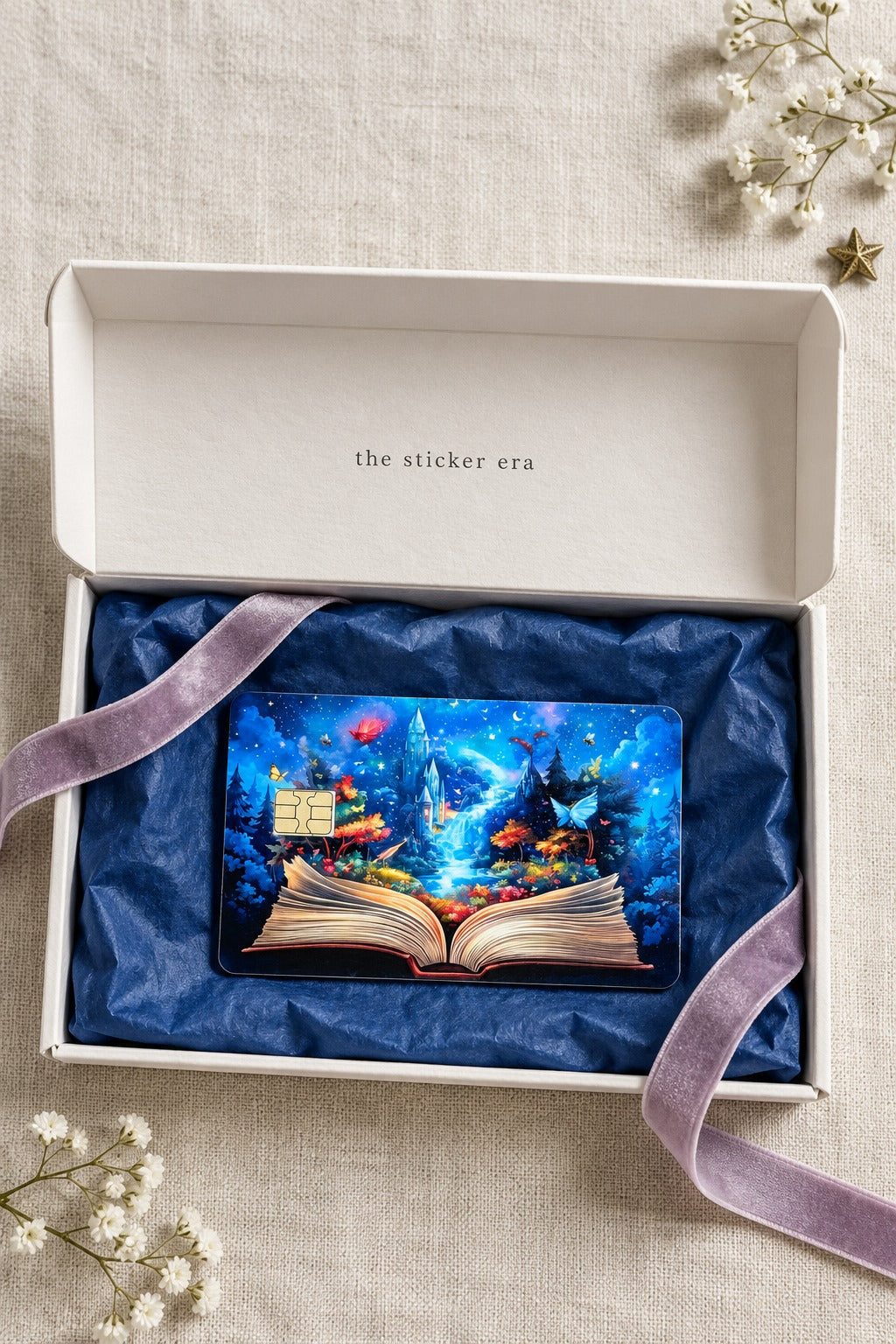 Enchanted storybook card skin in a white gift box with navy tissue and a lavender velvet ribbon by The Sticker Era