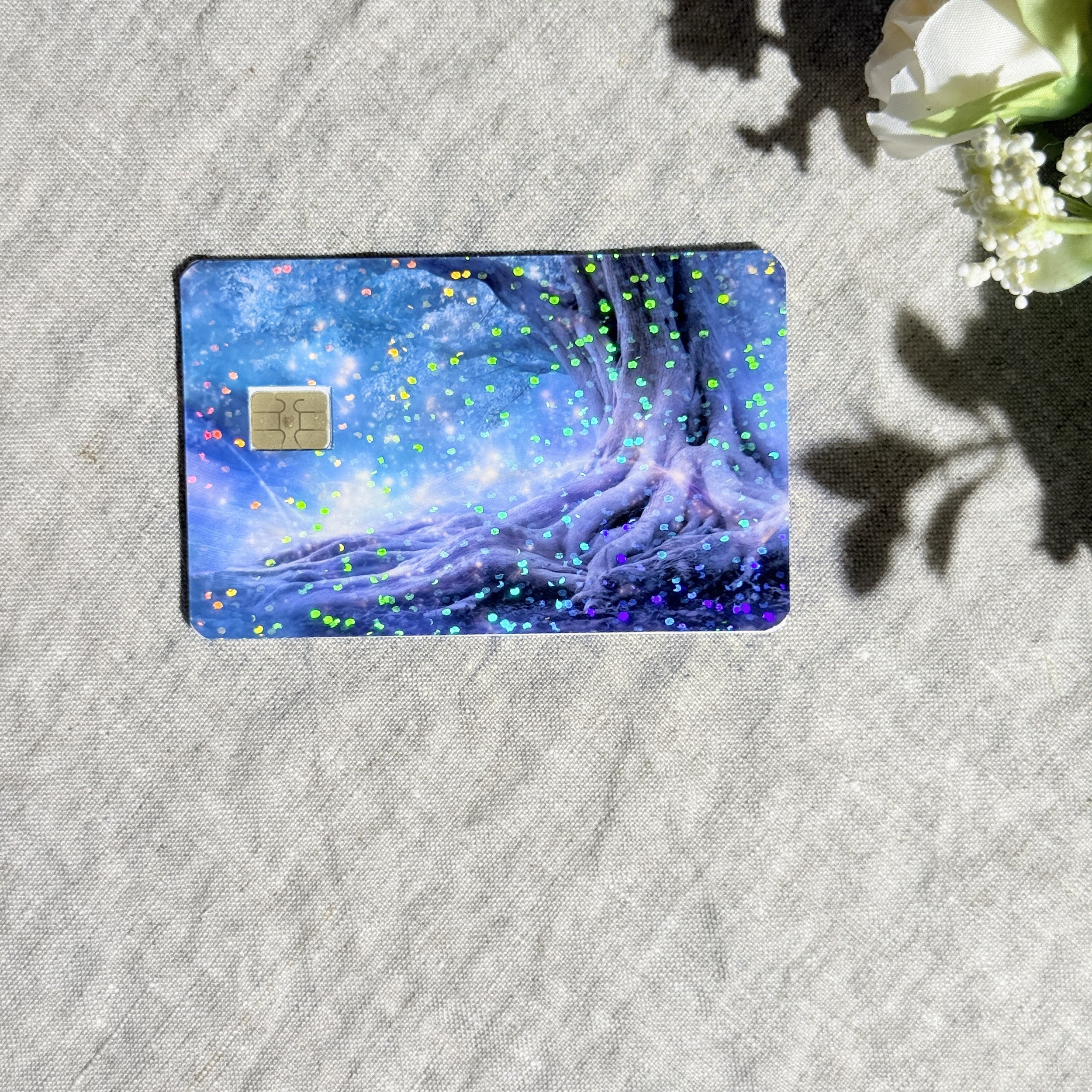 Close-up of holographic sparkle over the glowing fairy tree card skin by The Sticker Era