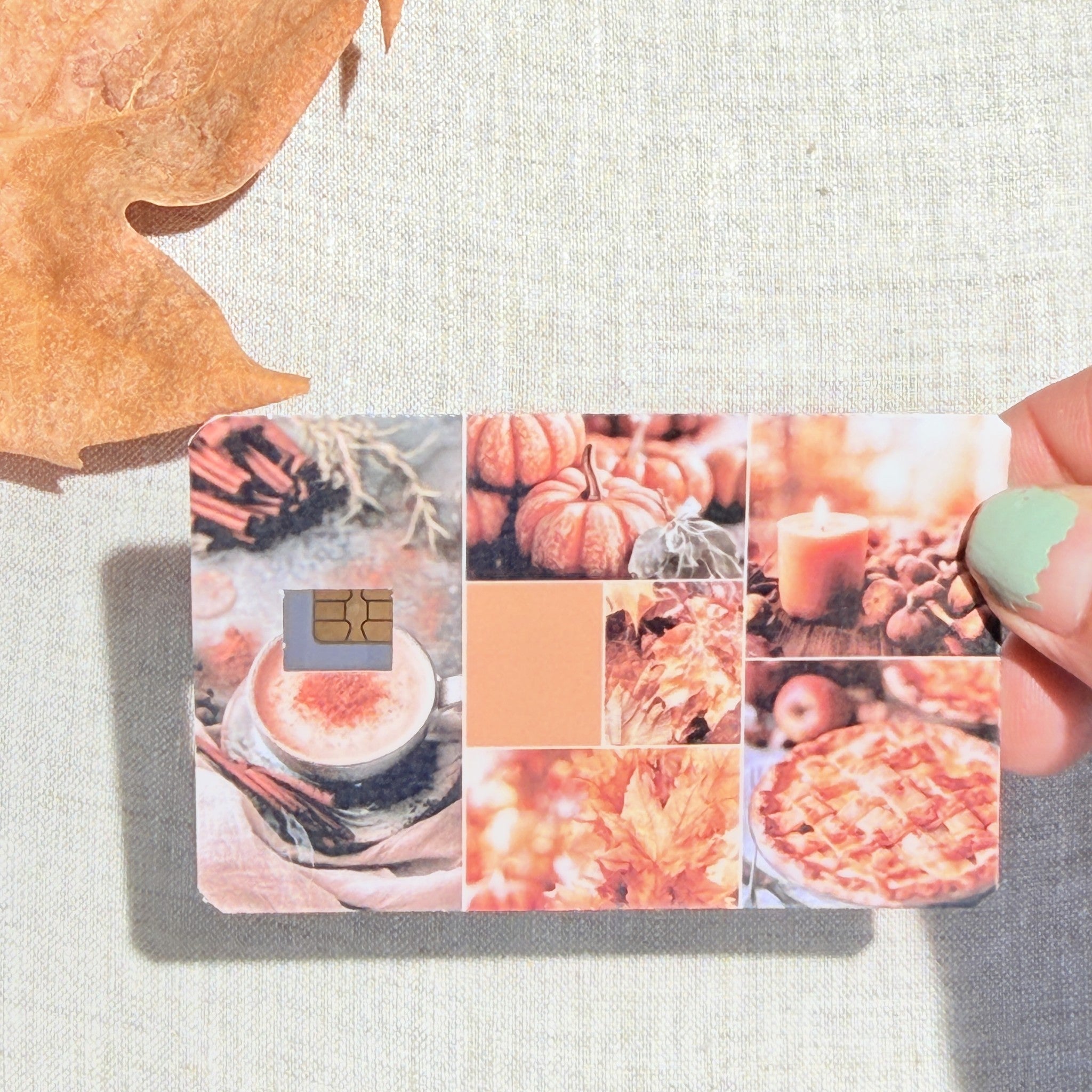 Blush autumn collage card skin held in hand for scale