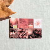 Cozy red fall collage debit card sticker shown flat on linen