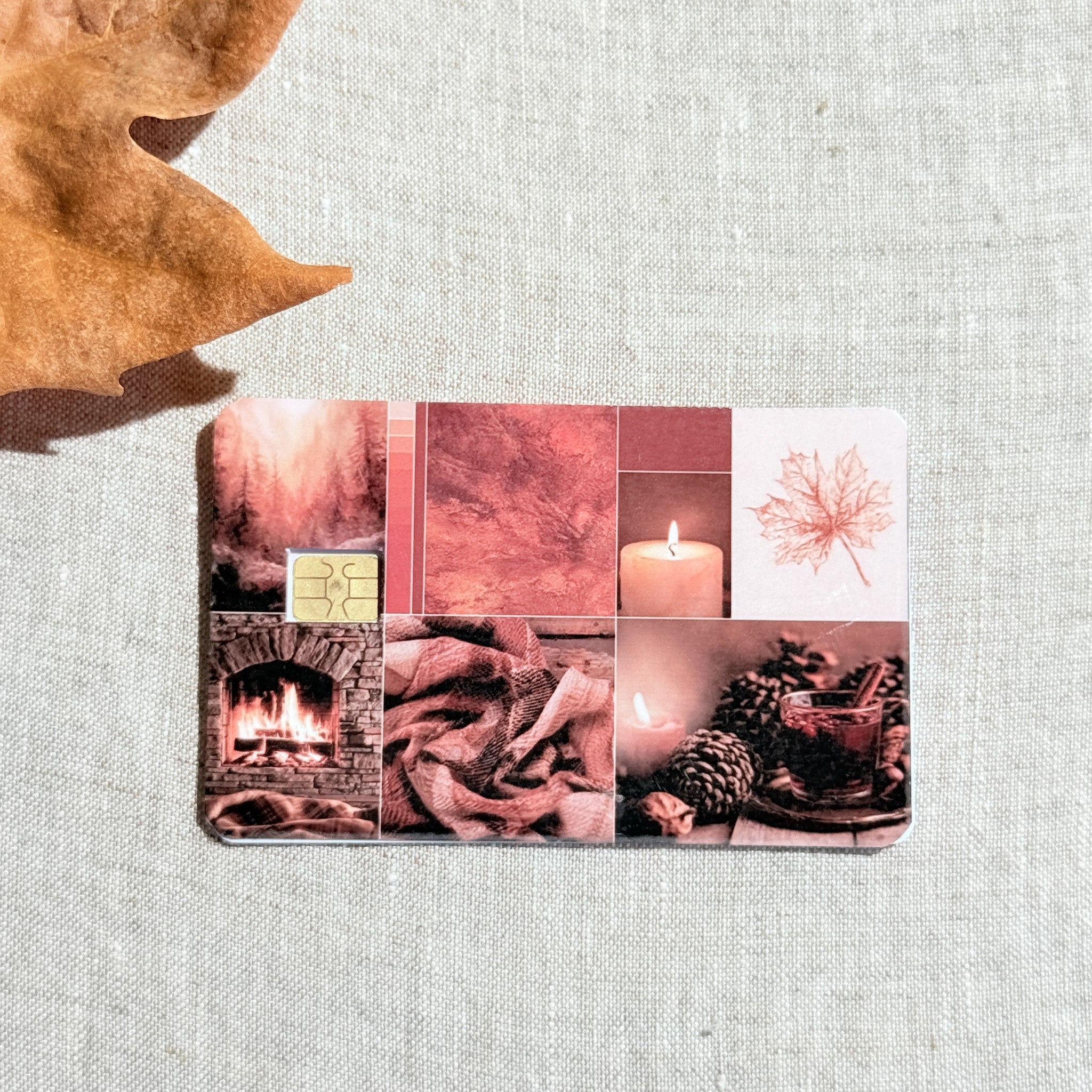 Cozy red fall collage debit card sticker shown flat on linen