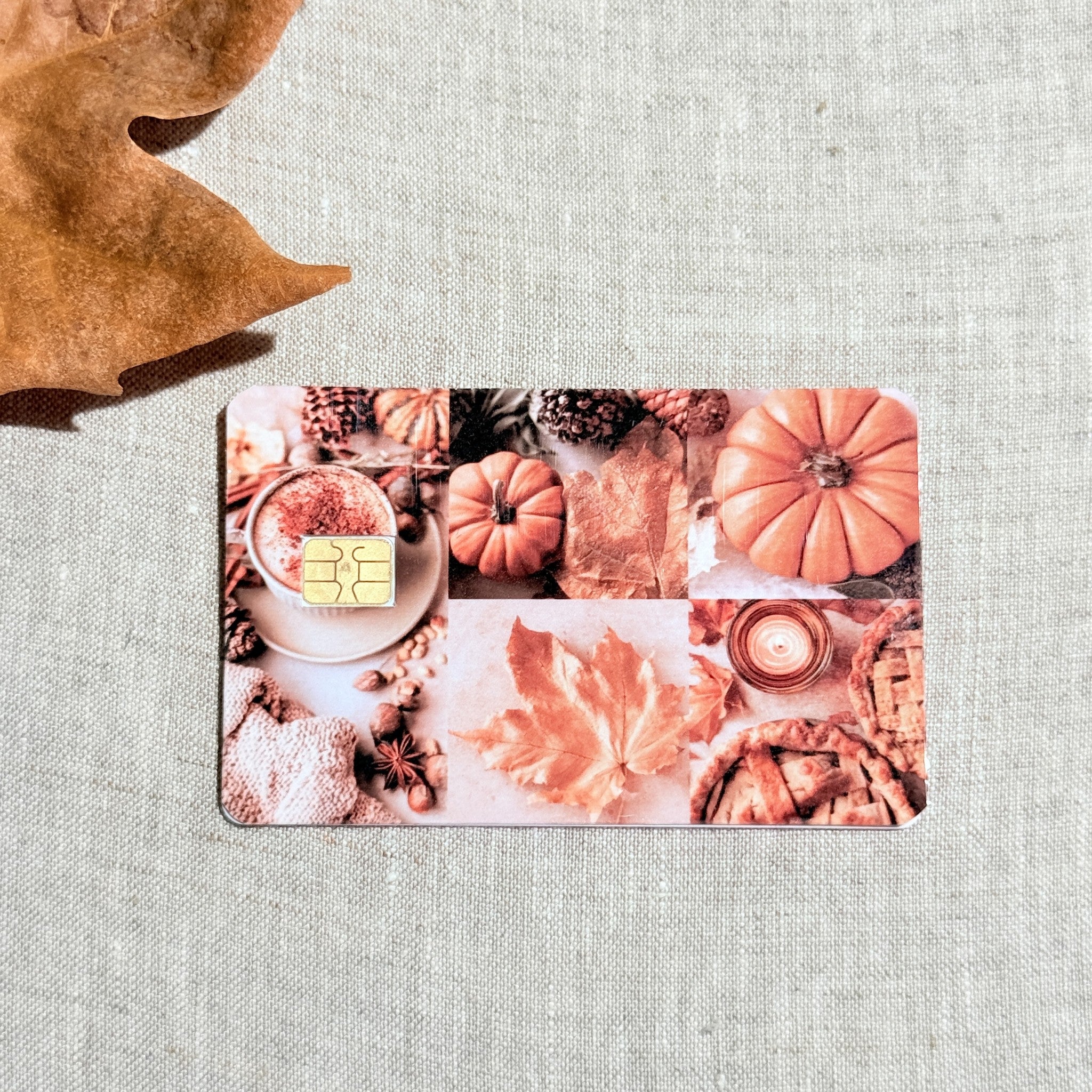 Orange fall collage debit card sticker shown flat on linen