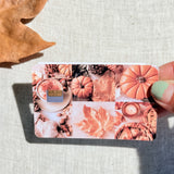 Pumpkin season card skin held in hand for scale