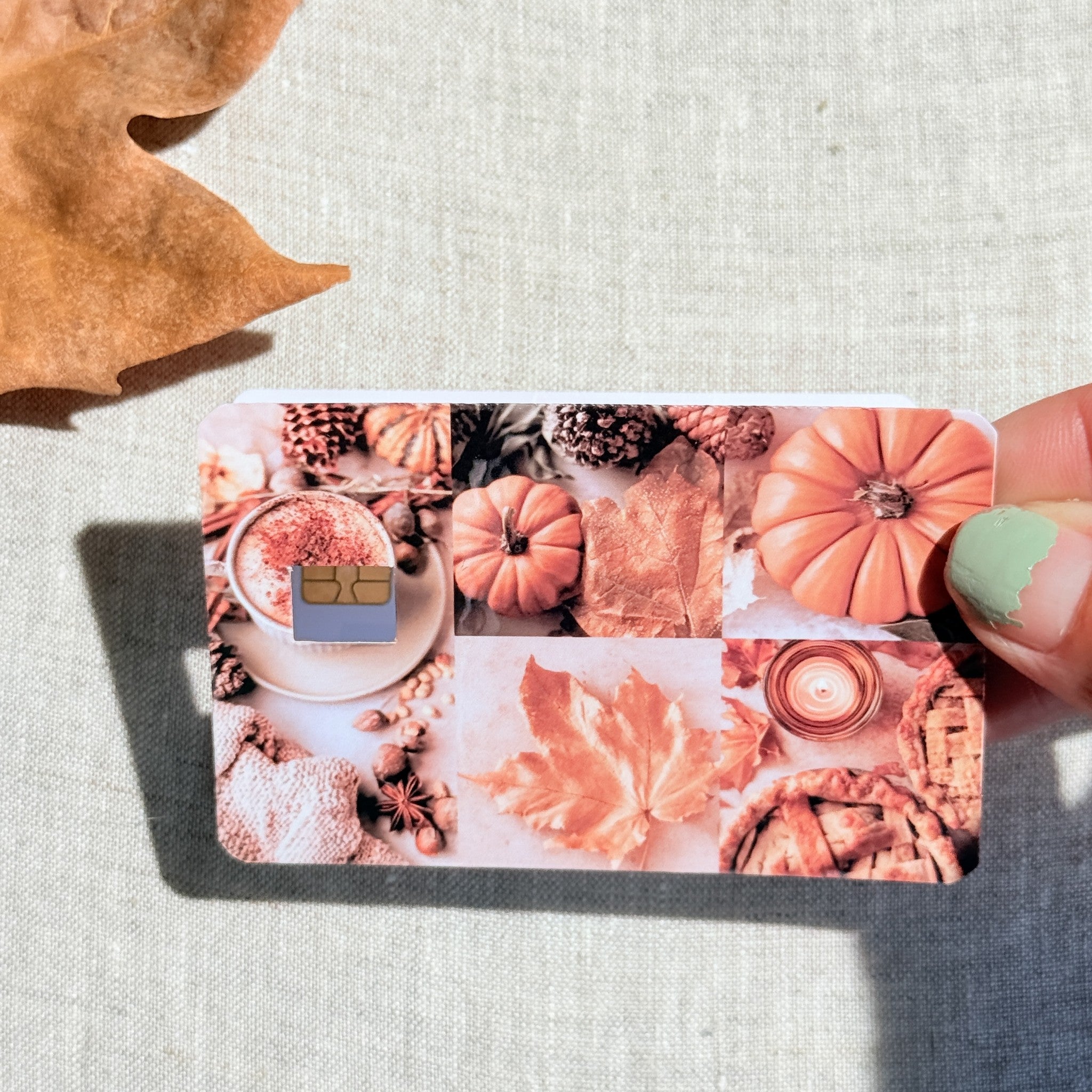 Pumpkin season card skin held in hand for scale