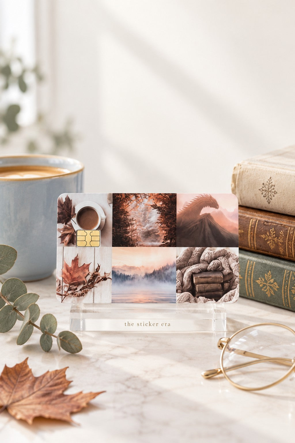 Autumn collage card skin on a clear stand with vintage books and a coffee mug by The Sticker Era