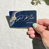 Hand holding the Girl Math debit card skin in sunlight by The Sticker Era