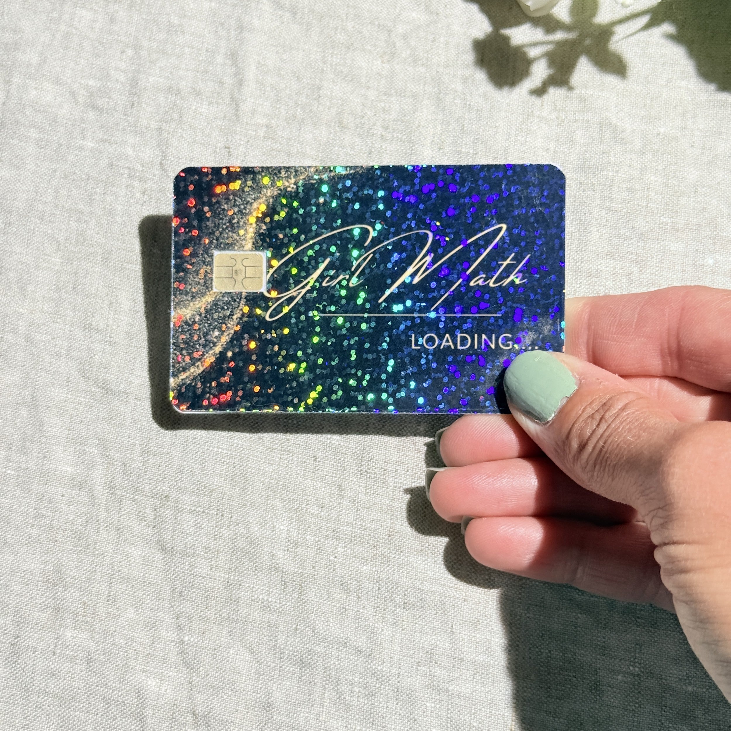 Girl Math card skin held at an angle catching the light by The Sticker Era