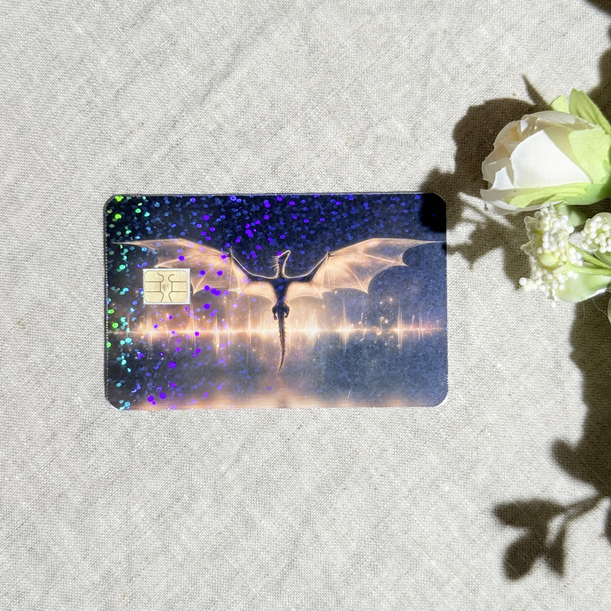 Golden dragon card skin with a dragon spreading its wings over a glowing lake on a debit card by The Sticker Era
