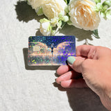 Close-up of rainbow sparkle across the dragon's wings on the card skin by The Sticker Era