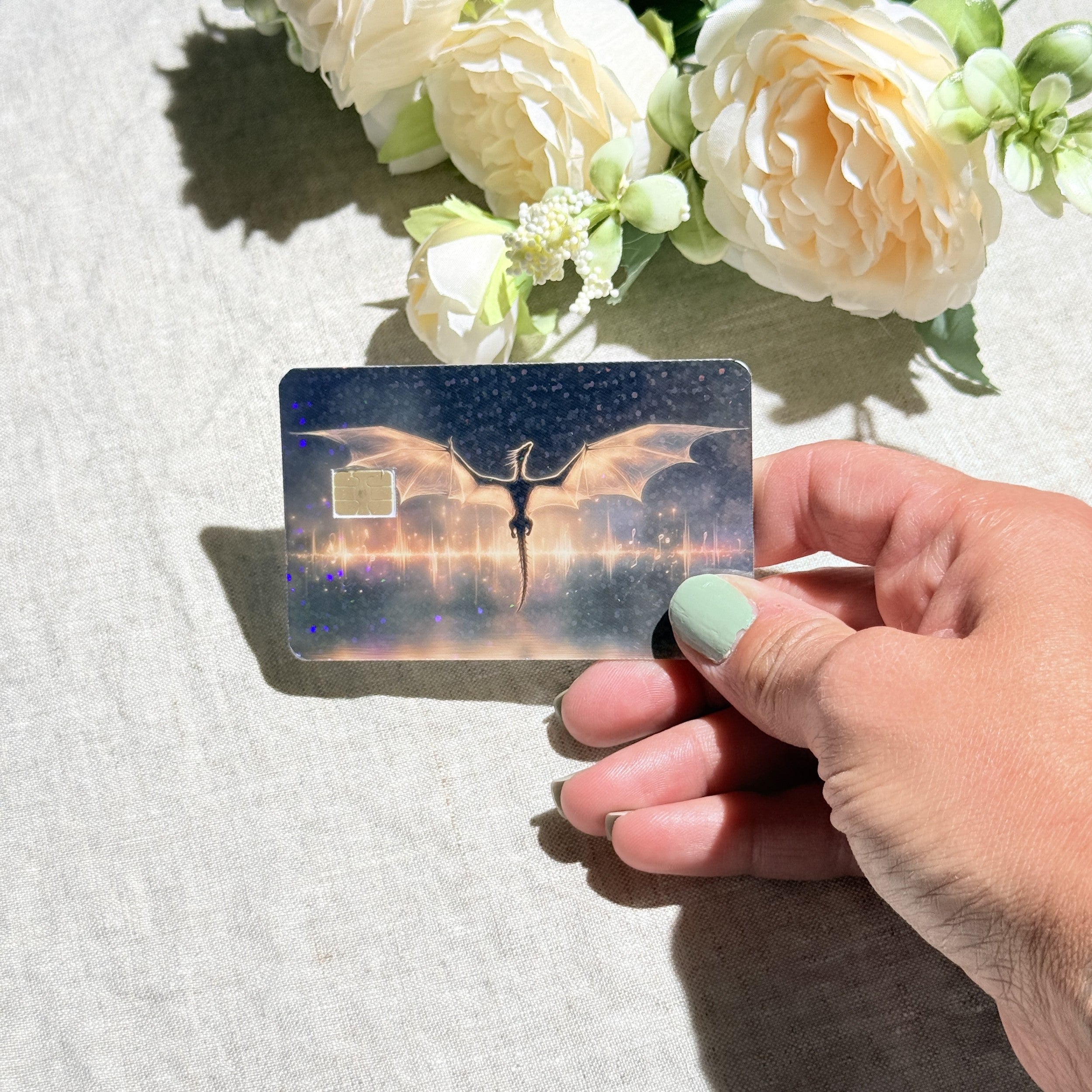 Dragon card skin held at an angle catching the light by The Sticker Era